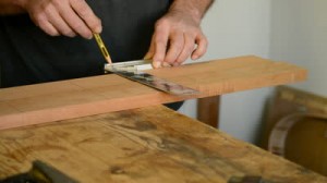 stock-footage-craftsman-or-carpenter-mark-out-in-a-table-wood
